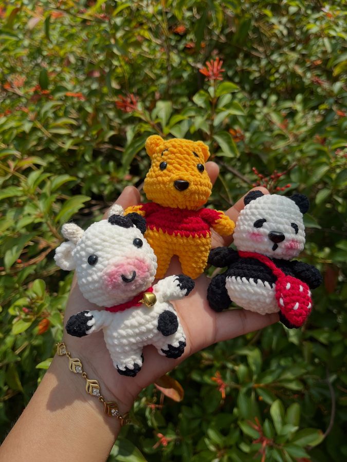 Three crochet keychain buddies - bear, cow and panda